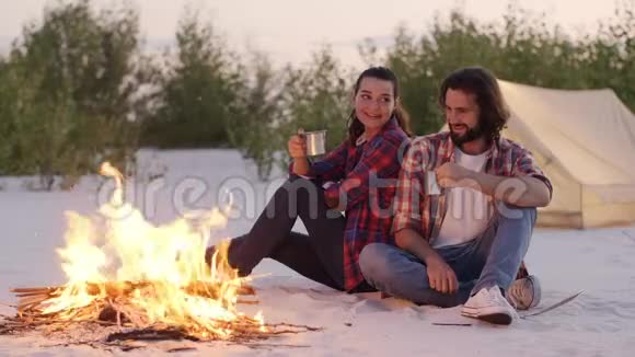 旅游情侣露营在大自然的篝火户外视频的预览图