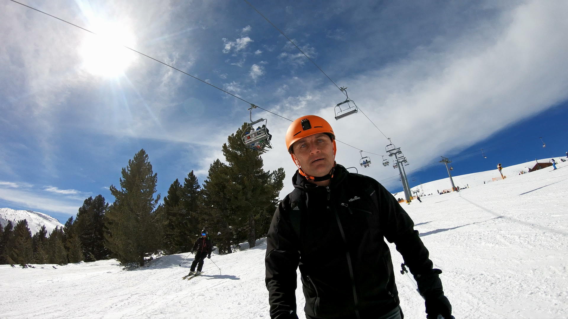 在高山滑雪度假胜地骑着滑雪者在山脚下慢慢游荡视频的预览图