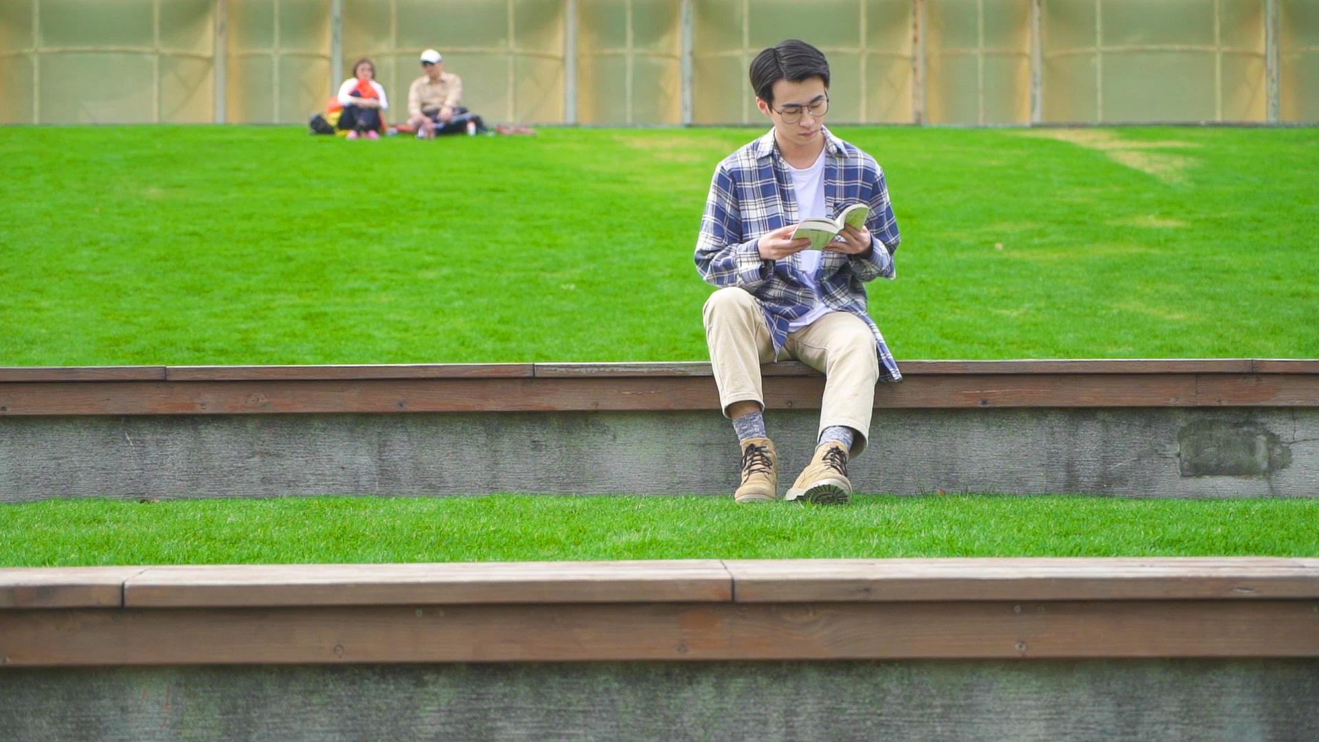 男青年坐在公园看书视频的预览图