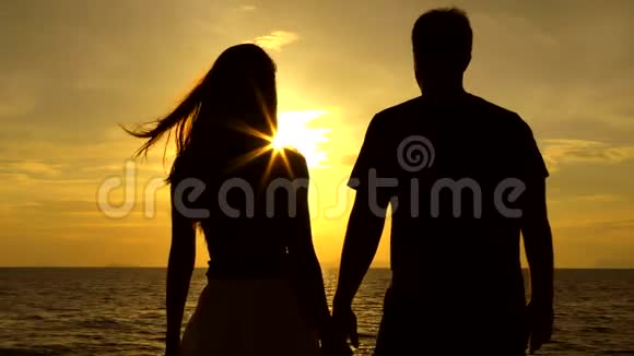 海滩上的浪漫情侣背景是五彩缤纷的日落视频的预览图