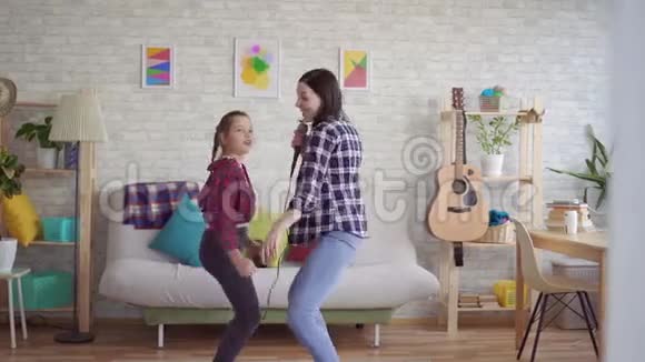 妈妈和女儿在家有感情地唱卡拉OK视频的预览图