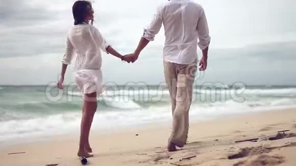 可爱的情侣在海滩上慢动作视频的预览图