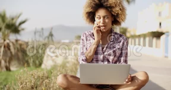 年轻的非洲妇女在大自然的笔记本电脑上工作视频的预览图
