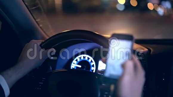 无法辨认的男子驾驶汽车夜间和网上冲浪电话危险概念视频的预览图