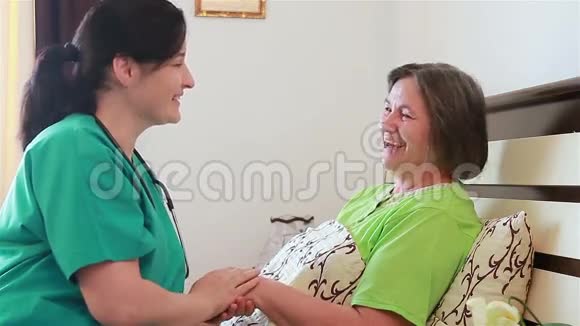 老年妇女与其家庭护理护士谈笑风生视频的预览图