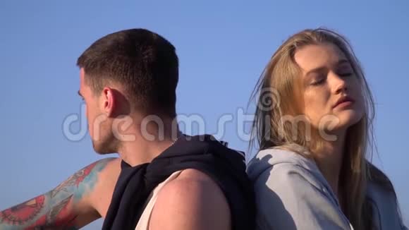 早晨吵架后一个男人坐在一个女人旁边对着蓝天视频的预览图