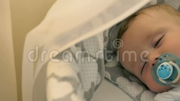 迷人的婴儿正睡在婴儿床上的肖像视频的预览图