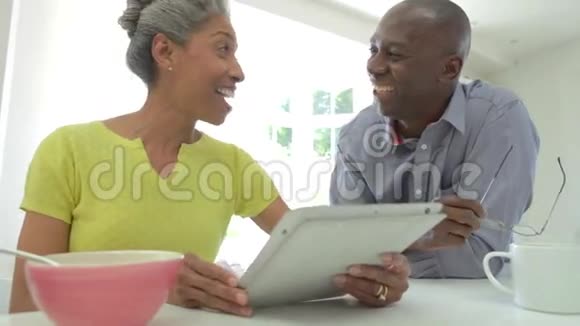 家中使用数码平板电脑的成熟非裔美国夫妇视频的预览图