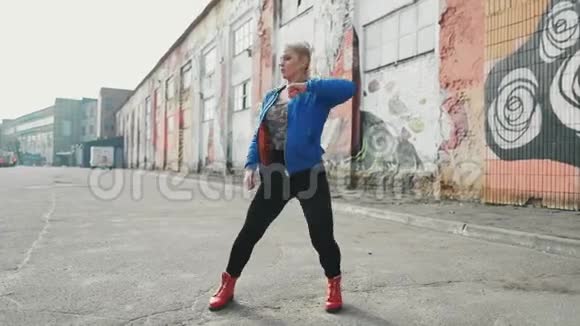金发女子舞蹈表演现代街舞摆姿势自由式街头都市4K股录像视频的预览图