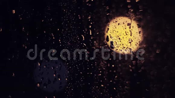 夜城的灯光雾状玻璃窗户上有液体雨滴悲伤和悲伤的情绪背景视频的预览图