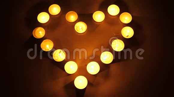 心形态燃烧的茶灯茶点燃蜡烛形成心脏的形状爱的主题概念视频的预览图