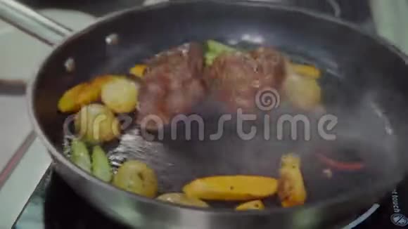 厨师用油在锅里炒肉和蔬菜抹布视频的预览图