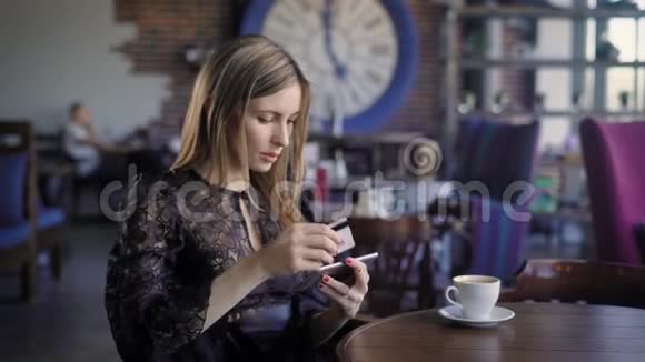 美丽的商务女性在网上订购飞机票坐在咖啡馆里女孩使用网上银行和视频的预览图