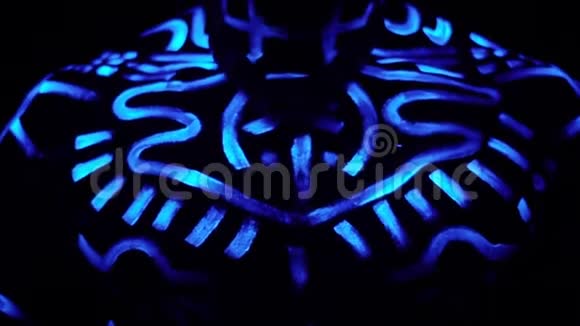 一个身穿霓虹灯图案的黑人双手叠起在黑暗中祈祷视频的预览图