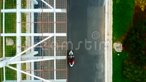 空中观景台年轻人在一个美丽的公园里骑摩托车视频的预览图