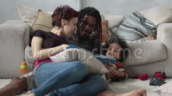 一家人坐在地板上一起读故事视频的预览图