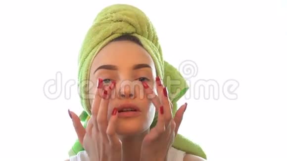 年轻女孩头上有毛巾导致眼霜视频的预览图