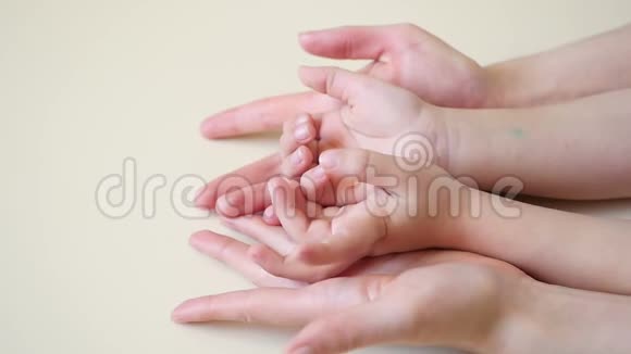 母亲的手慢慢地握住孩子手妈妈和宝宝快乐母爱视频的预览图