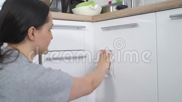 女孩打扫厨房用抹布清理污垢视频的预览图