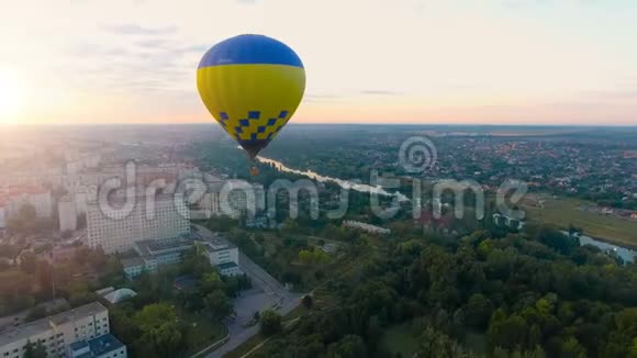 几个热气球漂浮在城市上空向地平线上升起的太阳飘来视频的预览图
