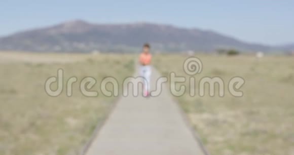 漂亮的女人在人行道上慢跑视频的预览图