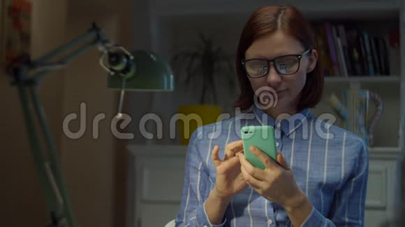 年轻的30多岁的女人在等待视频通话的互联网连接时使用手机在线教育过程青年视频的预览图