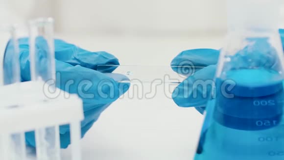 一只手戴着蓝色橡胶手套的大型实验室视频的预览图
