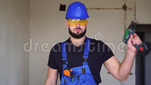 一个男性建筑工人用电动螺丝刀的肖像视频的预览图