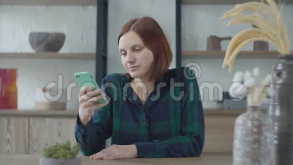 30多岁的年轻女工坐在木桌旁拿着宜家花瓶上网女人打字视频的预览图