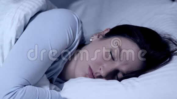 女孩睡觉皱眉噩梦和噩梦的概念年轻迷人的白种人女孩独自睡在床上视频的预览图