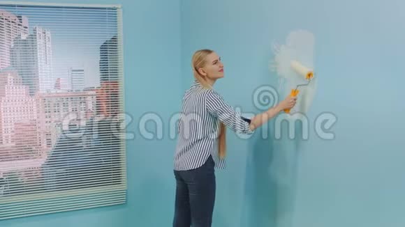 女人重新装饰她的办公室粉刷墙壁视频的预览图