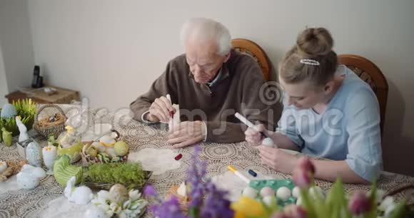 年长的男人和女人在画鸡蛋视频的预览图