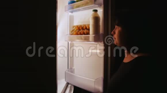 胖女人晚上打开冰箱拿蛋糕饥饿暴饮暴食饮食视频的预览图