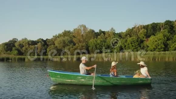 人们乘绿色的木船航行视频的预览图