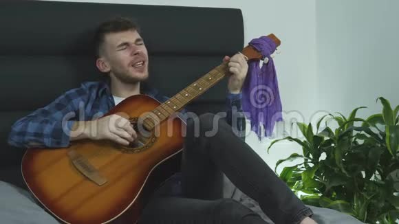 长胡子的年轻人弹着吉他唱歌用吉他演奏时的情绪演唱视频的预览图