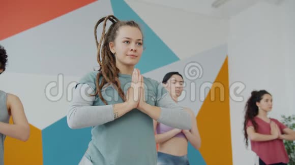 快乐的女瑜伽生在做平衡运动手牵手视频的预览图