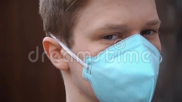 戴着医用面罩的年轻人看着摄像机防止冠状病毒视频的预览图