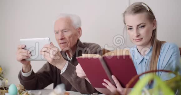 年轻女子在数码平板电脑上与祖父上网视频的预览图