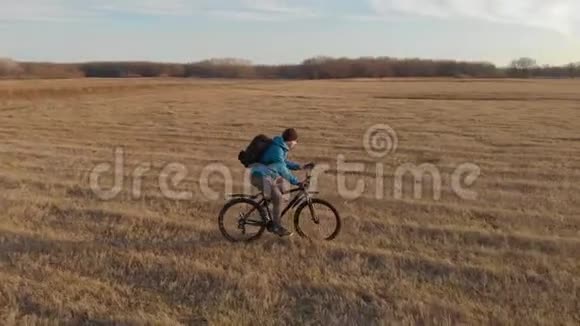 日落时骑自行车骑在山上的空中景色视频的预览图