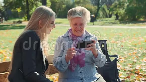 老奶奶给孙女看智能手机照片视频的预览图