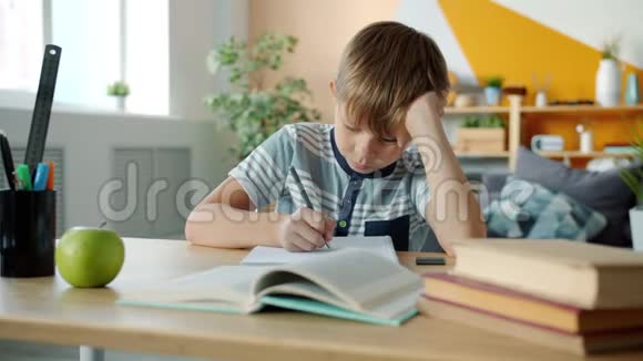 一幅聪明的孩子在家做作业在书桌旁写字视频的预览图
