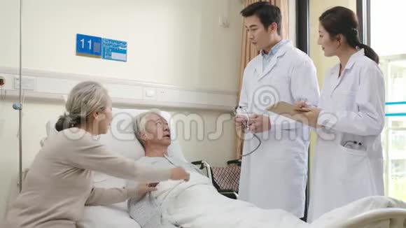 年轻亚洲医生在医院病房检查老年病人视频的预览图