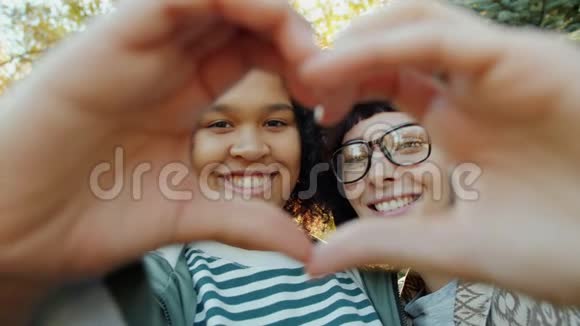 幸福的年轻女性朋友用双手微笑表示心意的画像视频的预览图