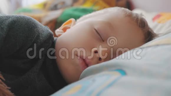 安静的小男孩睡觉时躺在床上家庭母健康和护理的概念视频的预览图