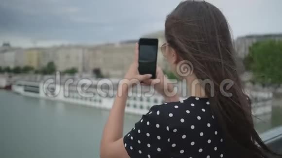 女孩在桥上拍城市照片匈牙利布达佩斯视频的预览图
