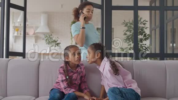 小混血女孩在沙发上分享秘密视频的预览图