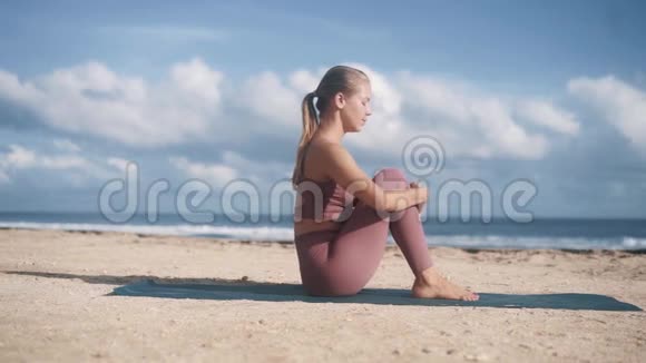 集中女性伸展身体在海边做瑜伽视频的预览图