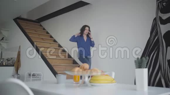 自信的褐发白种人女商人走下楼梯在家吃饭忙碌成功的女人视频的预览图