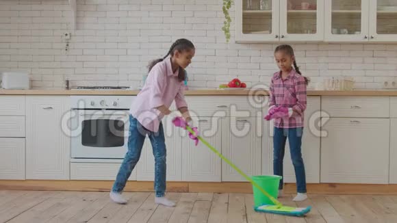 家政混合种族姐妹在地板上擦拭视频的预览图