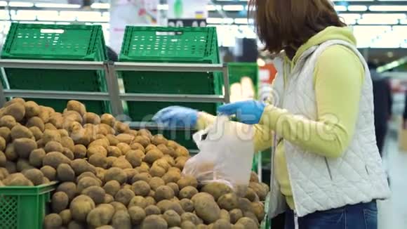大流行病期间在杂货店买土豆的女顾客戴面具视频的预览图